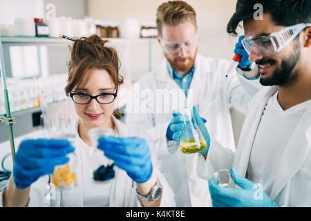 Group of chemistry students working in laboratory Stock Photo