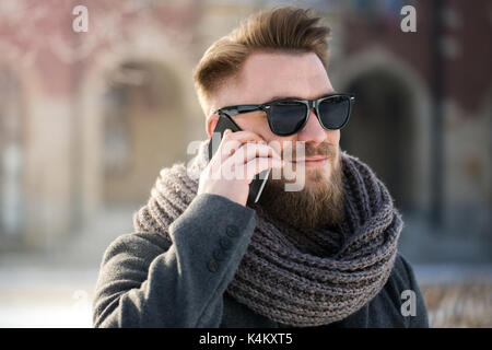 Man talking on the phone in winter scenery Stock Photo