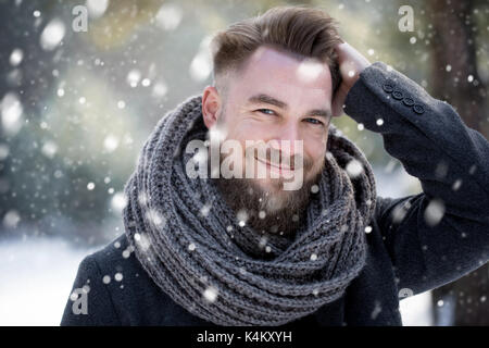 Man combing his hair in winter while snowing Stock Photo