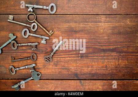 Old keys on old wooden background Stock Photo