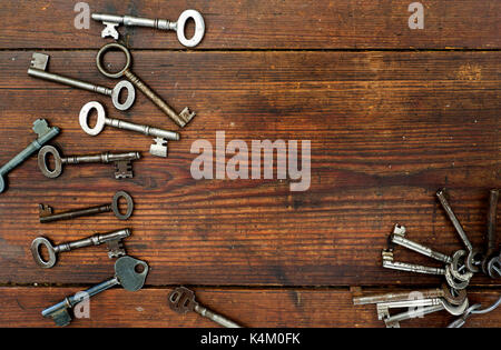 Old keys on textured wooden background Stock Photo