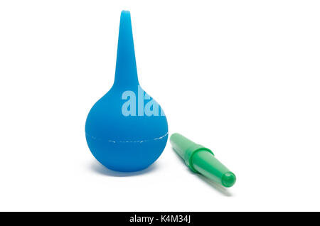 Blue enema and green dropper isolated on white background. Stock Photo