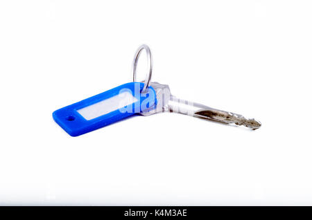 Steel key with blue key fob on a white background Stock Photo