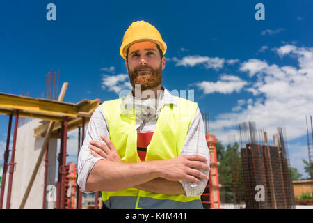 Portrait of a determined young worker looking at camera with con Stock Photo