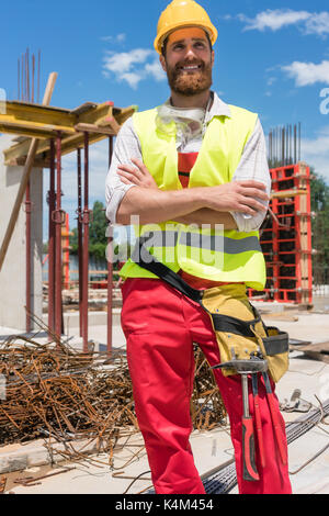 Portrait of a determined young worker looking at camera with con Stock Photo