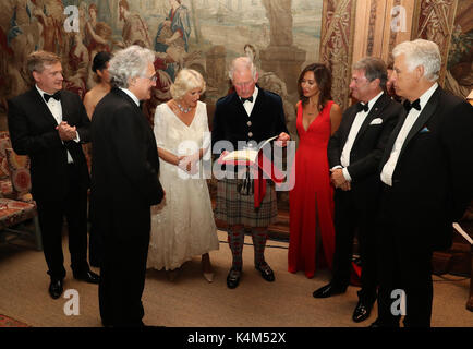 The Prince of Wales and Duchess of Cornwall, known as the Duke and Duchess of Rothesay in Scotland are presented a facsimile of a manuscript written by Charles Hubert Parry by John Suchet(second left) alongside Aled Jones(far left), Myleene Klass, Alan Titchmarsh and Nick Owen(far right) as they attend Classic FM's 25th anniversary recital at Dumfries House in Cumnock. Stock Photo