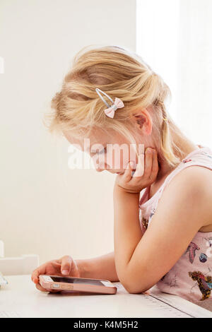 Little girl playing with smart phone Stock Photo