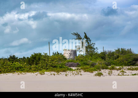 An overgrown beachside Martello tower, a 19th century coastal fortification on a beach on the south coast of Barbuda, Antigua and Barbuda, West Indies Stock Photo