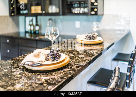 Grapes on plate of modern granite kitchen bar in luxury apartment or restaurant Stock Photo