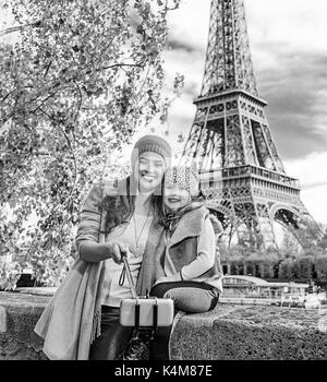 Autumn getaways in Paris with family. smiling mother and child travellers on embankment in Paris, France taking selfie using selfie stick Stock Photo