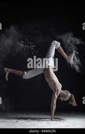 Flexible yoga man doing hand balance asana vrischikasana. Stock Photo