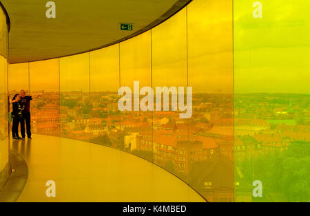 A couple taking  admiring the view from 'Your rainbow panorama', Olafur Eliasson's work of art on the roof of the ARoS Kunstmuseum in Aarhus, Denmark Stock Photo