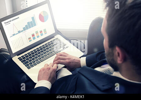 Man working with laptop. Financial diagrams on notebook screen. Screen finance data laptop charts graph diagram concept Stock Photo