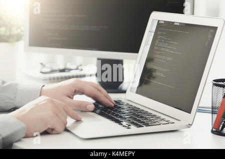 Programmer working busy software developing in company office. programmer code computer program technology office software hands on laptop concept Stock Photo