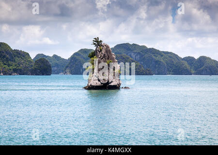 cruising among beautiful limestone rocks and secluded beaches in Ha Long bay, UNESCO world heritage site, Vietnam Stock Photo