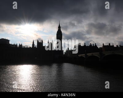 View of Houses of Parliament and Big Ben in silhouette at sunset. Seen from just below Westminster Bridge. London, UK. Stock Photo