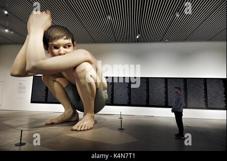 Ron Mueck's Boy at The ARoS Aarhus Kunstmuseum in Aarhus, Denmark. The Australian artist’s (b. 1958) sculpture has become one of the landmarks of the  Stock Photo