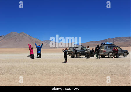 Tourists taking pictures on a jeep trip through Southern Bolivia