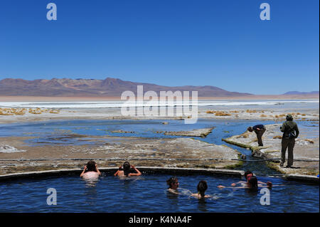 Tourists at the Termas de Polques hot springs, Reserva Nacional de Fauna Andina Eduardo Abaroa, Southern Bolivia Stock Photo