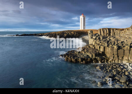 Basalt columns and the Kálfshamarsvík lighthouse near Skagaströnd on the Skagi peninsula, North Iceland Stock Photo