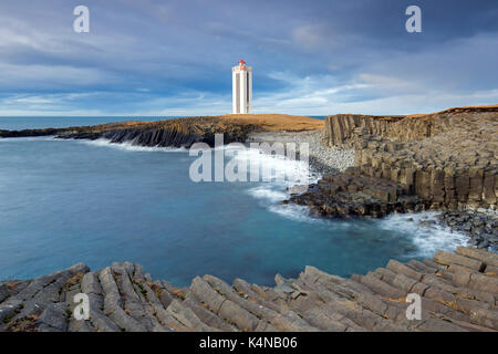 Basalt columns and the Kálfshamarsvík lighthouse near Skagaströnd on the Skagi peninsula, North Iceland Stock Photo