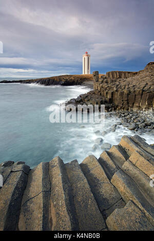 Basalt columns and the Kálfshamarsvík lighthouse near Skagaströnd on the Skagi peninsula, North Iceland Stock Photo