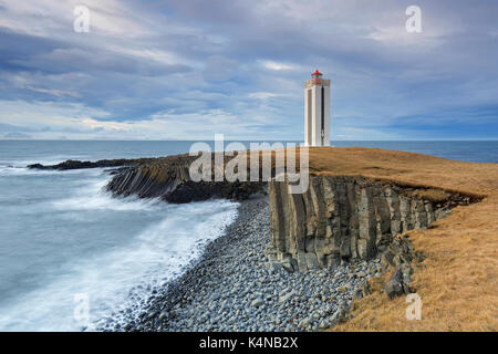 Basalt columns and the Kálfshamarsvík lighthouse near Skagaströnd on the Skagi peninsula, North Iceland Stock Photo