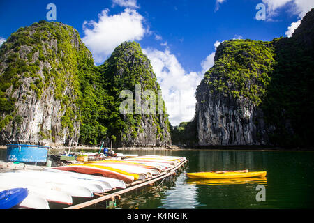 cruising among beautiful limestone rocks and secluded beaches in Ha Long bay, UNESCO world heritage site, Vietnam Stock Photo