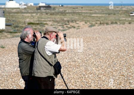 Bird spotters on the beach at Dungeness Kent UK Stock Photo