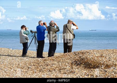 Bird spotters on the beach at Dungeness Kent UK Stock Photo