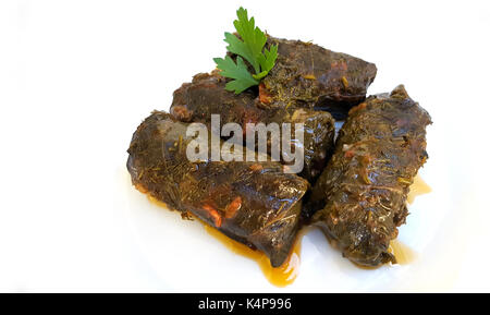 Stuffed Mediterranean vine leaves, or dolmades on white background Stock Photo