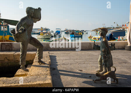 Statue with bronze fishing basket hi-res stock photography and images -  Alamy