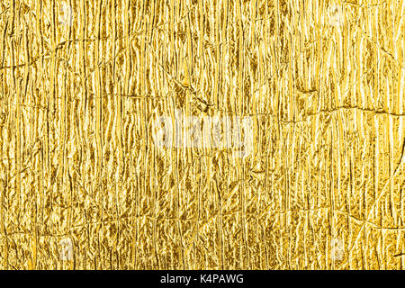 Close up of the golden foil abstract textured background. Stock Photo