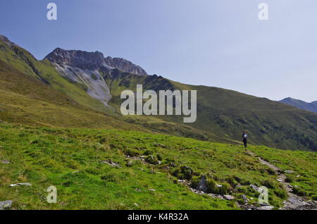 Young femaie trekker hiking on a trail in the Dolomites, Italy, towards the summit of Monte Cavallino on the Austrian border
