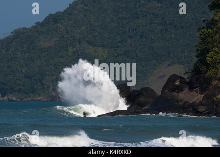 Wave crashing on a rock in Ilhabela, São Paulo, Brazil Stock Photo