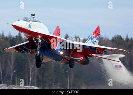 Kubinka, Moscow Region, Russia - February 19, 2014: Mikoyan Gurevich MiG-29UB 11 BLUE jet fighter of Strizhi The Swifts aerobatics team taking off at  Stock Photo