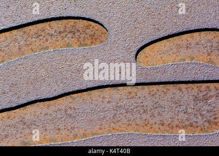 Abstract textures and backgrounds: two toned etched and corroding metal with waving, curvy lines. Stock Photo