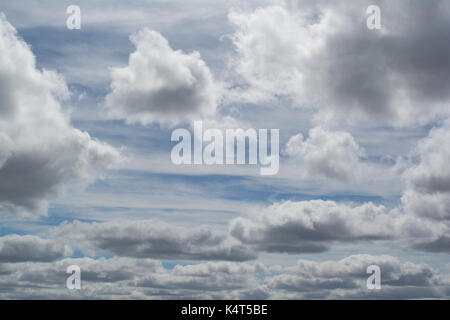 Unusual cloud formations, taken in the Murraylands of South Australia. Puffy thick clouds in front of wispy cloud lines against the blue sky that peek Stock Photo