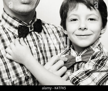 father with son in bowties on white background, casual look family Stock Photo