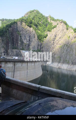 Lake Vidraru, an artificial lake in Fagaras mountains, Romania is reservoir lake created in 1965 on Arges River for electricity production. Stock Photo