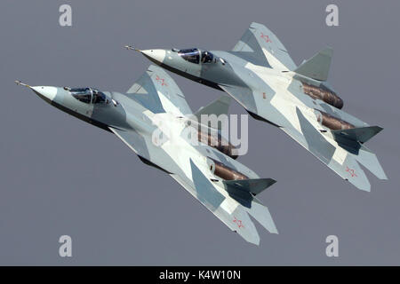 Zhukovsky, Moscow Region, Russia - August 24, 2013: Pair of Sukhoi T-50 PAK-FA 052 BLUE and 051 BLUE modern russian jet fighters performing demonstrat Stock Photo