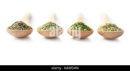 Wooden spoon filled with dried herbs on white background Stock Photo