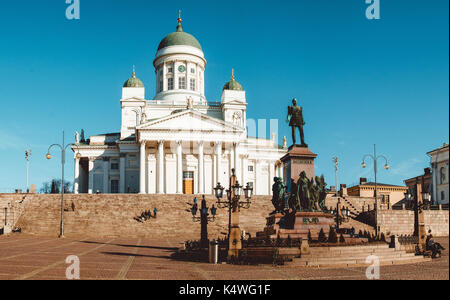 HELSINKI, FINLAND - MARCH, 17, 2015: Lutheran Cathedral St Nicholas Church and a monument to Alexander II on the Senatorial area in Helsinki, Finland Stock Photo