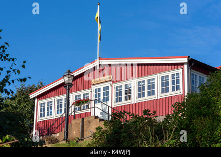 Karlskrona, Sweden - August 28, 2017: Travel documentary of the city surroundings. Storstugan, a red and white community house in allotment area. Flag Stock Photo