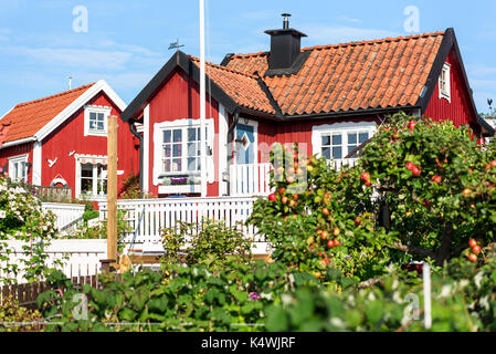 Karlskrona, Sweden - August 28, 2017: Travel documentary of the city surroundings. Allotment houses or cabins with fruit tree and garden in front. Stock Photo