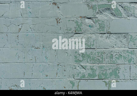 Old  wall with painted and shabby uneven plaster. Cracked Brick Wall Background.  Vintage Brickwork Structure With Peeled Plaster.  Wall With Damaged  Stock Photo