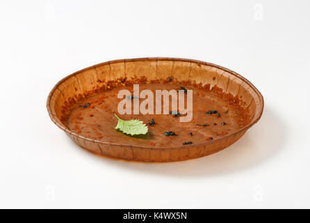 empty round paper baking pan on white background Stock Photo