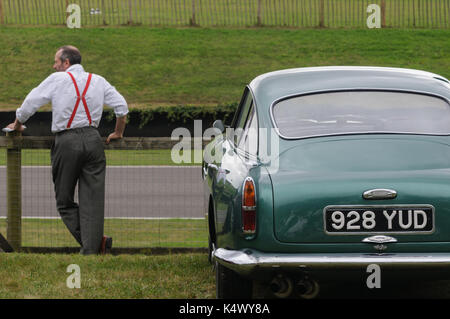 Classic Aston Martin and Man in Red Braces at Goodwood Revival Stock Photo