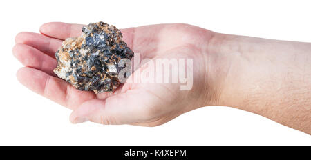 piece of zinc and lead mineral ore (sphalerite with galena) on male palm isolated on white background Stock Photo