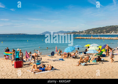 Juan les Pins, France - September 1st, 2017: Busy beach in Juan les Pins, Cote d'Azur, France. The city is famous for its annal Jazz Festival Stock Photo